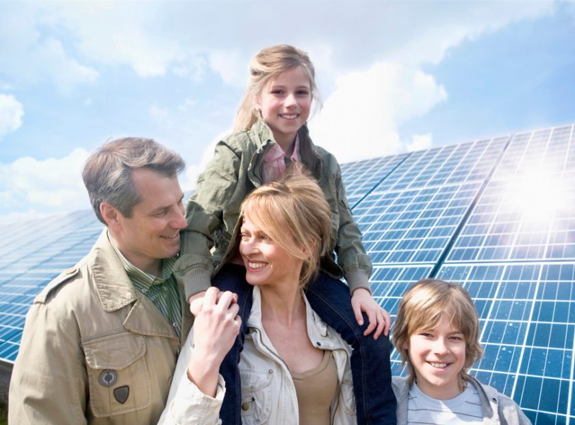 Family,Posing,Together,In,Front,Of,Solar,Panels,In,Munich,