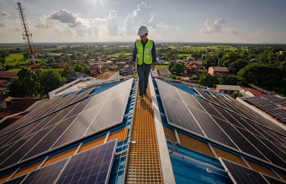 Solar roofing engineering technician working on top of high building